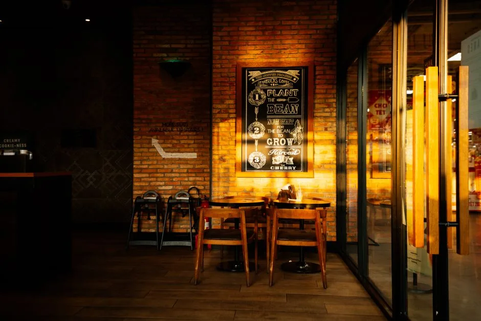 The play room — warm brick walls, wooden tables and chairs ready for a night of games