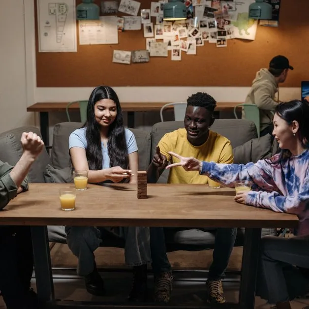 A group laughing around a table mid-game
