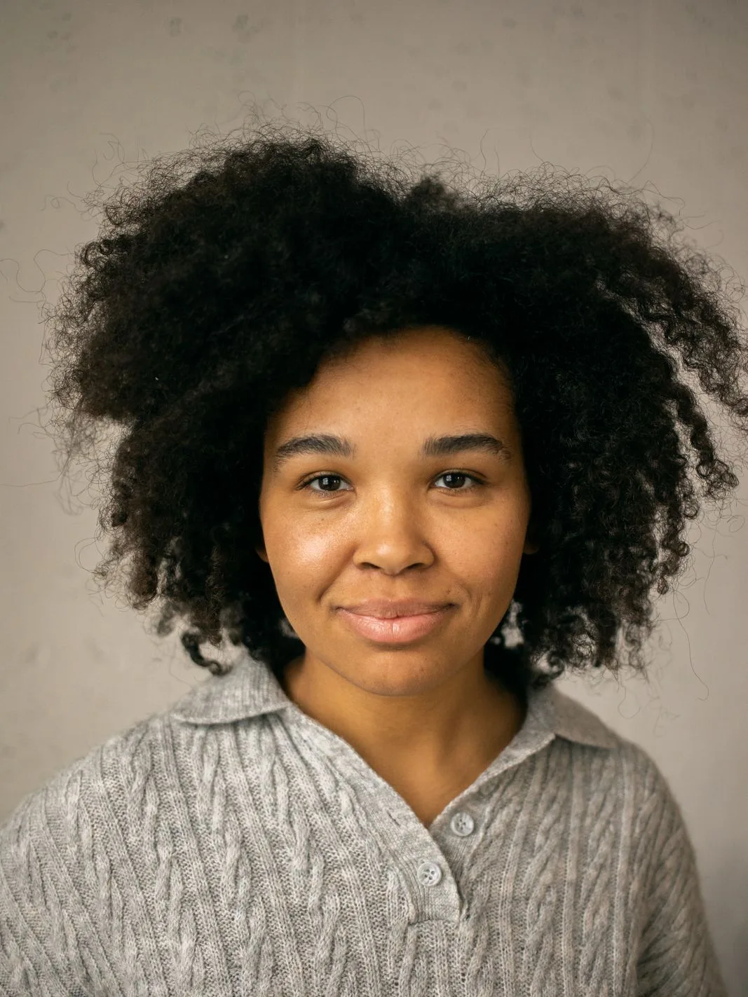 Rosa, the card game buyer, smiling against a plain grey background