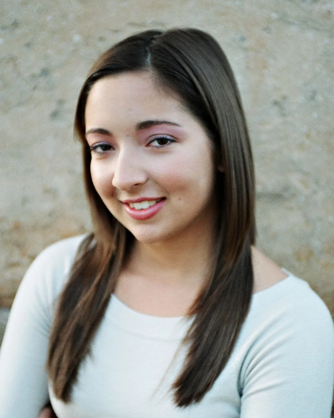Sam, the owner, smiling against a warm neutral background