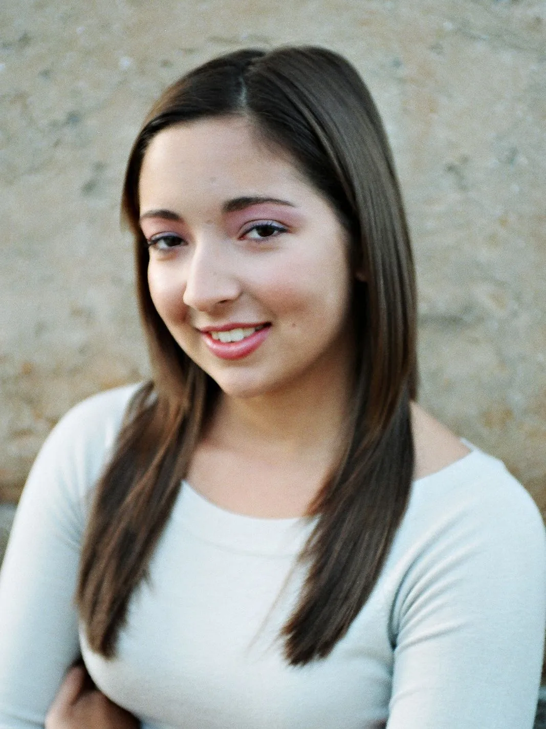Sam, the owner, smiling against a warm neutral background